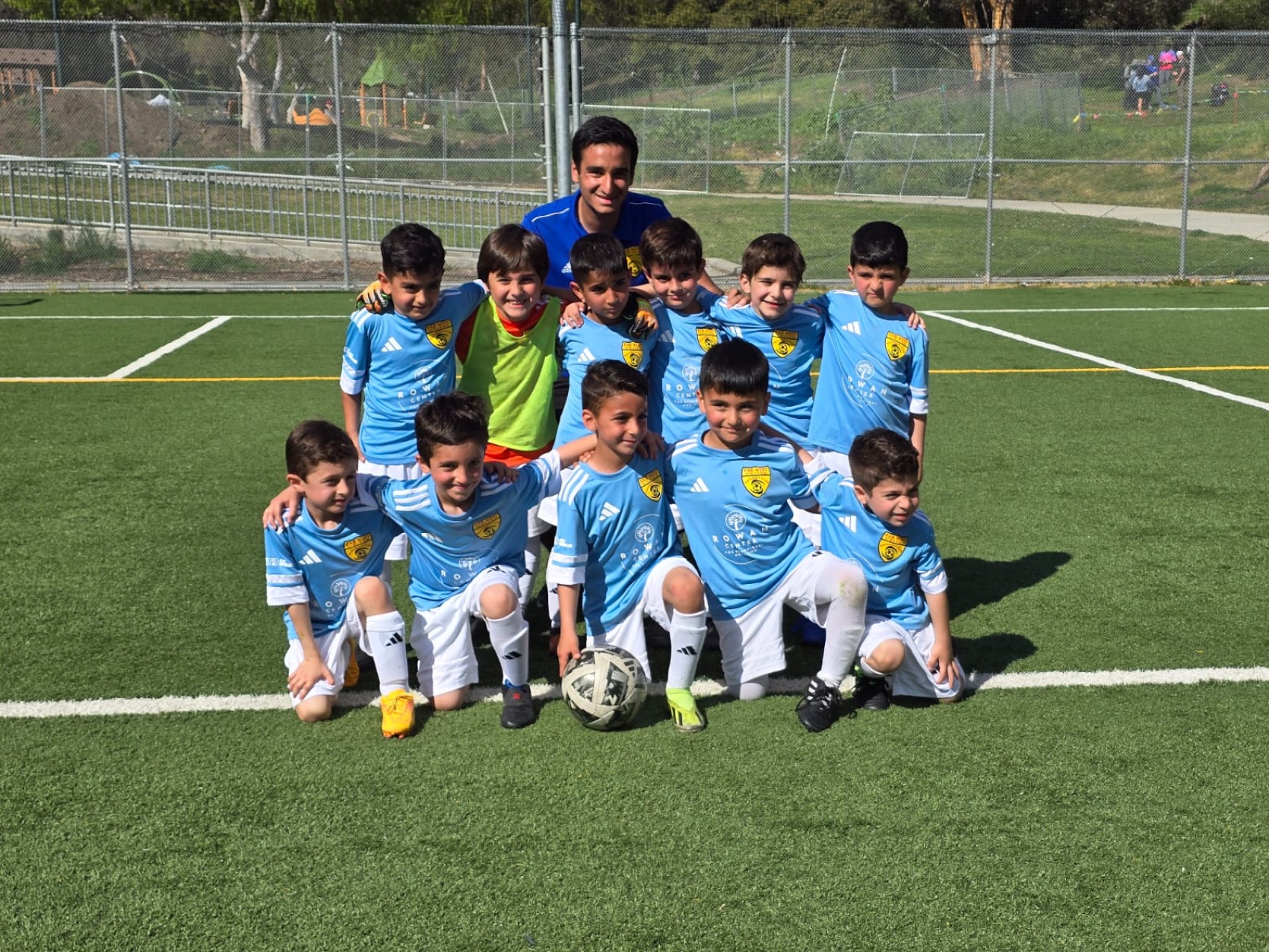 Coach Arame with his team on the turf